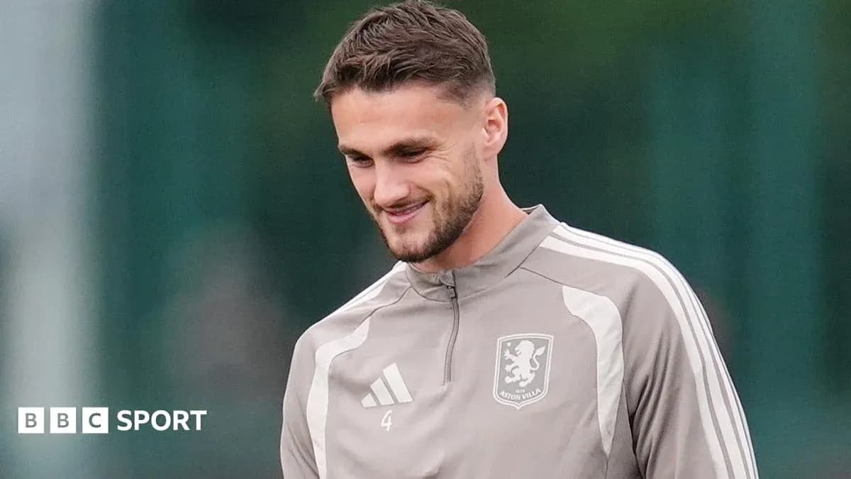 Player in Aston Villa training kit smiling during practice
