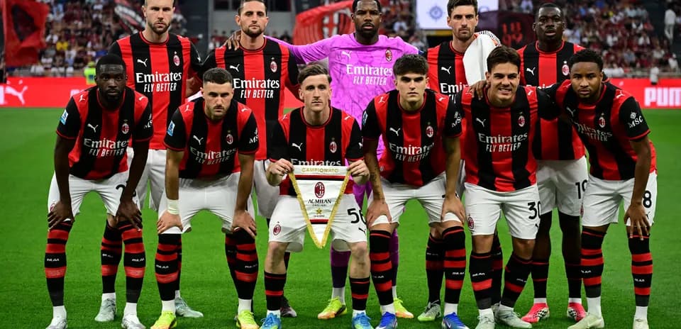 AC Milan players posing with championship banner