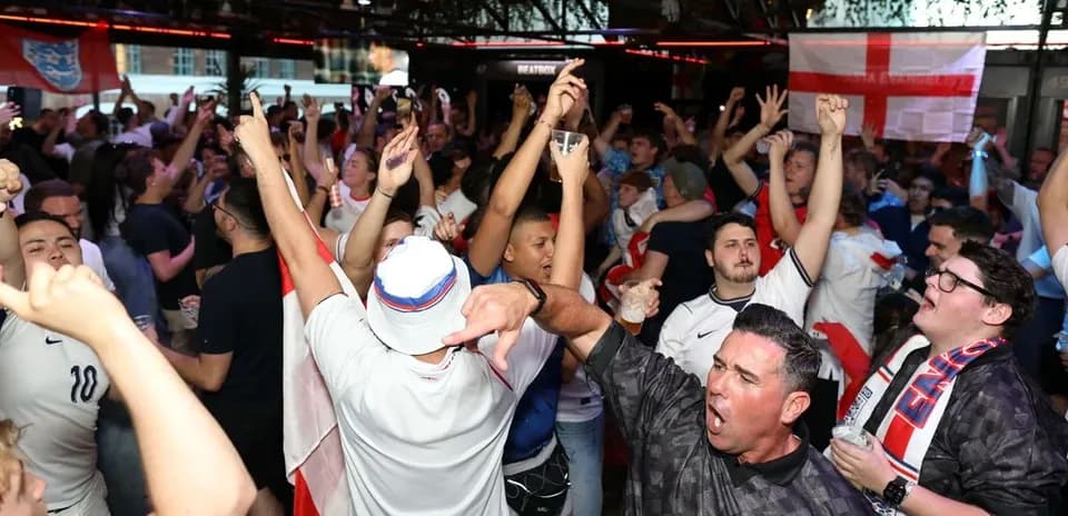 Crowd of fans celebrating in a sports bar