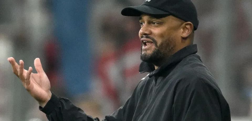 Coach gesturing during a football match on sidelines