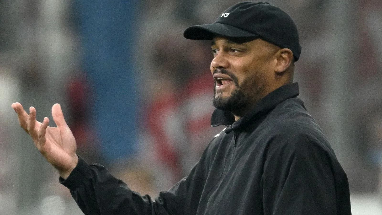 Coach gesturing during a football match on sidelines