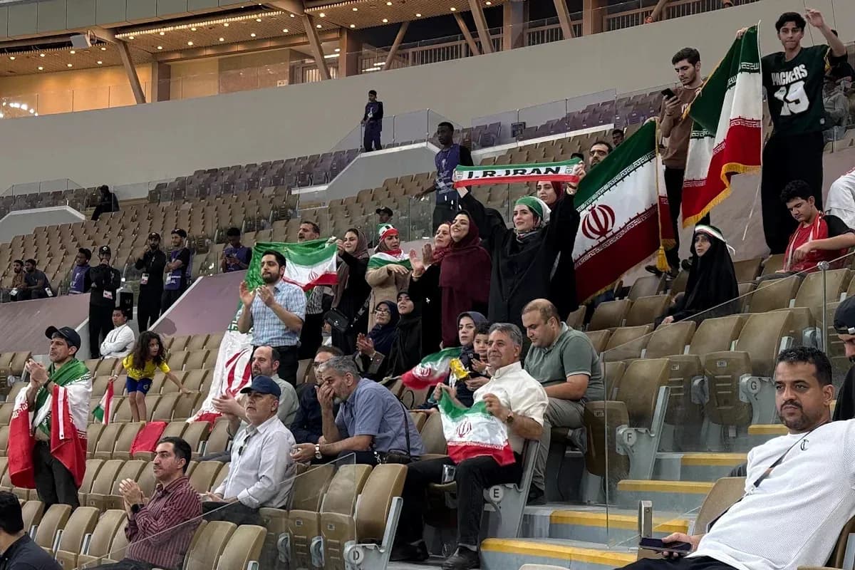 Iranian fans cheering with flags in stadium