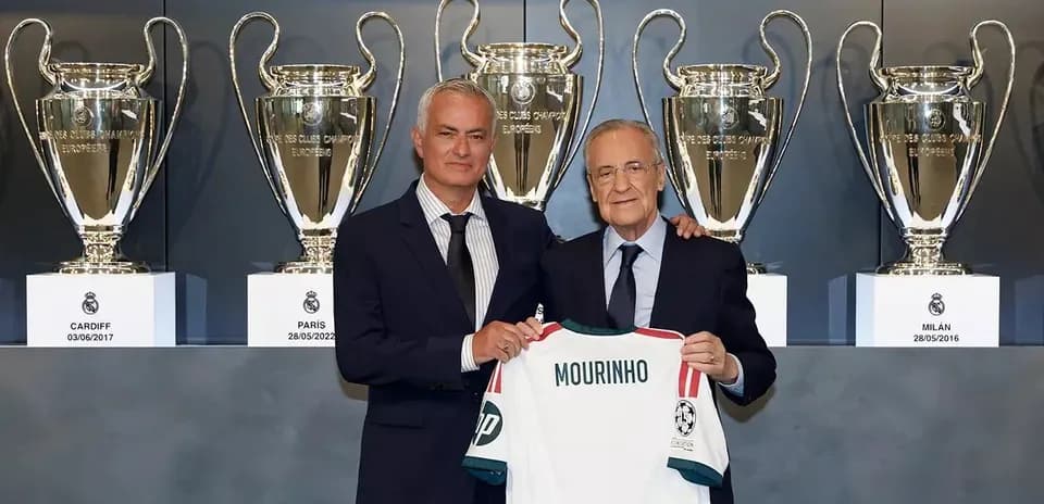 Jose Mourinho holding jersey with Florentino Perez