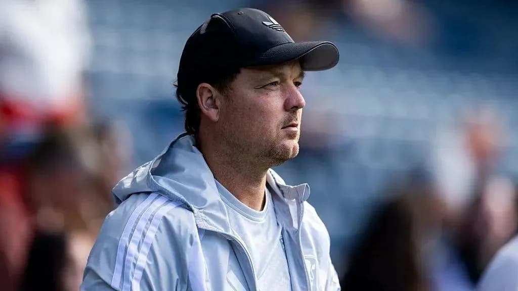 Coach observing from the sidelines during match