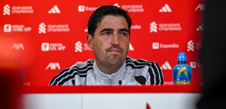 Manager at press conference with branded backdrop