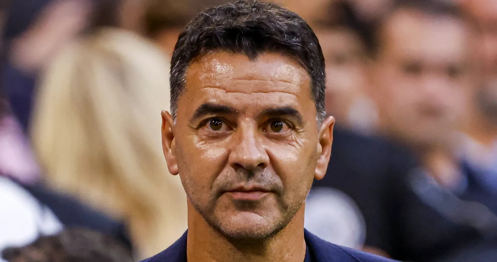 Coach observing during a match in the stands