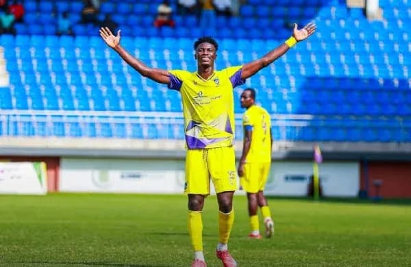 Player celebrating on the field with teammates