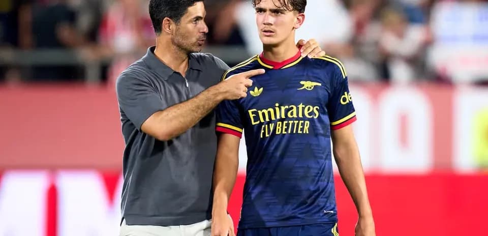 Coach speaking to player on the field