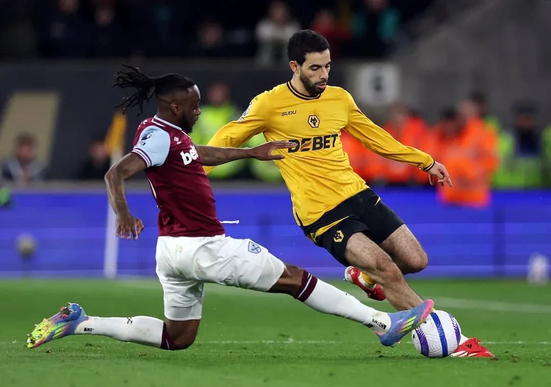 West Ham player tackling Wolves player during match