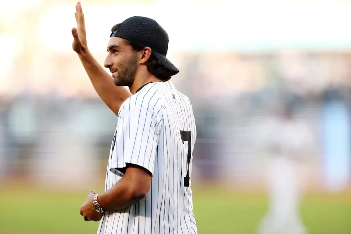 Man waving while wearing a pinstripe jersey