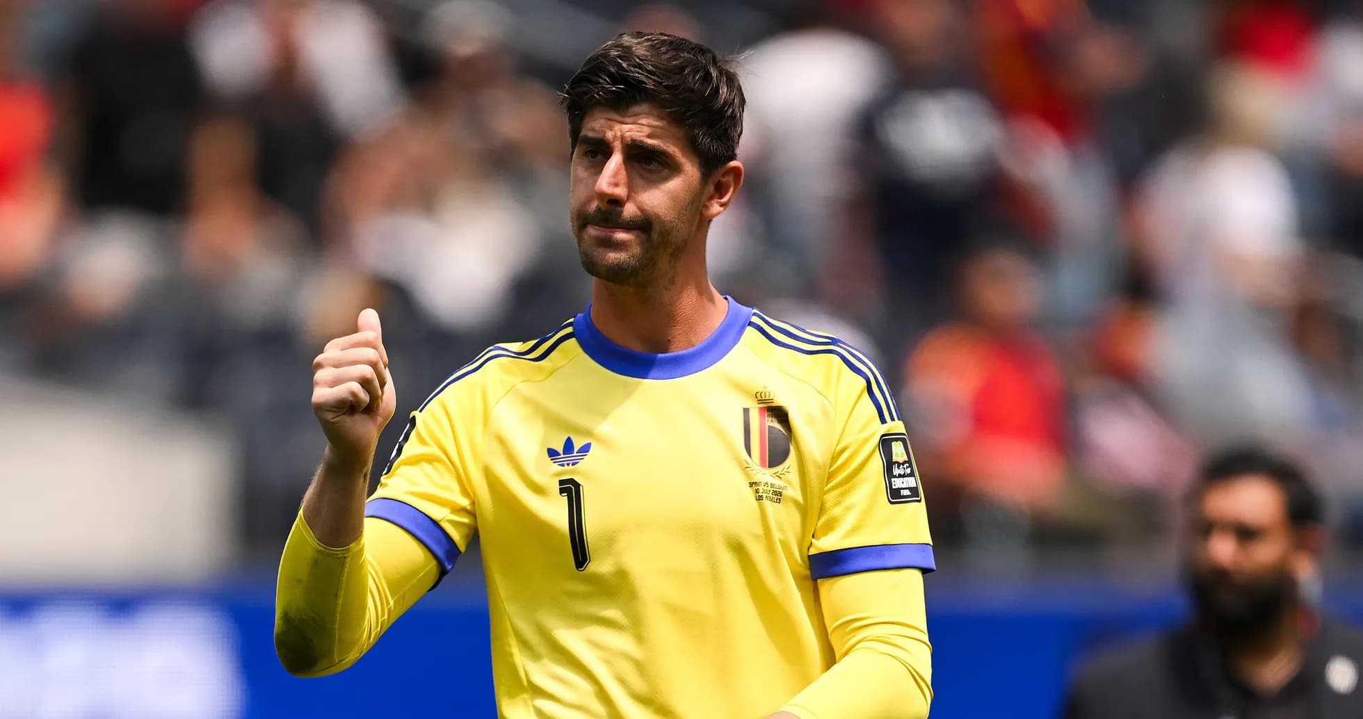 Goalkeeper gesturing during a match in yellow kit