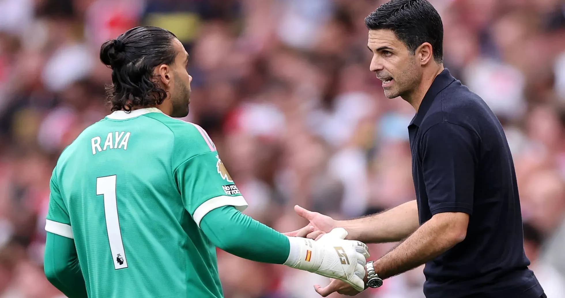 Goalkeeper and manager discussing strategy during match