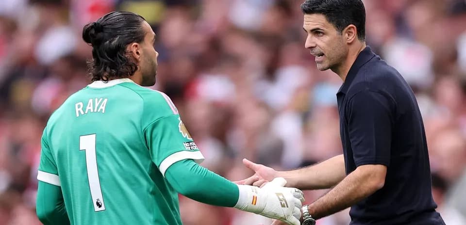 Goalkeeper and manager discussing strategy during match