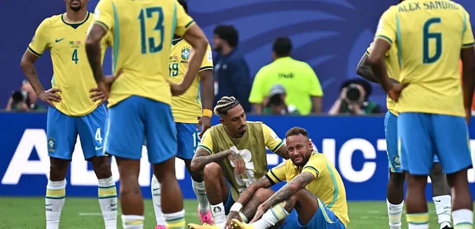 Brazilian players gathered around injured Neymar on field