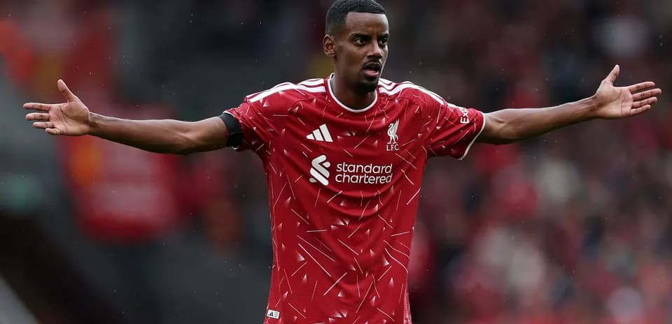 Player gesturing during a match in Liverpool kit
