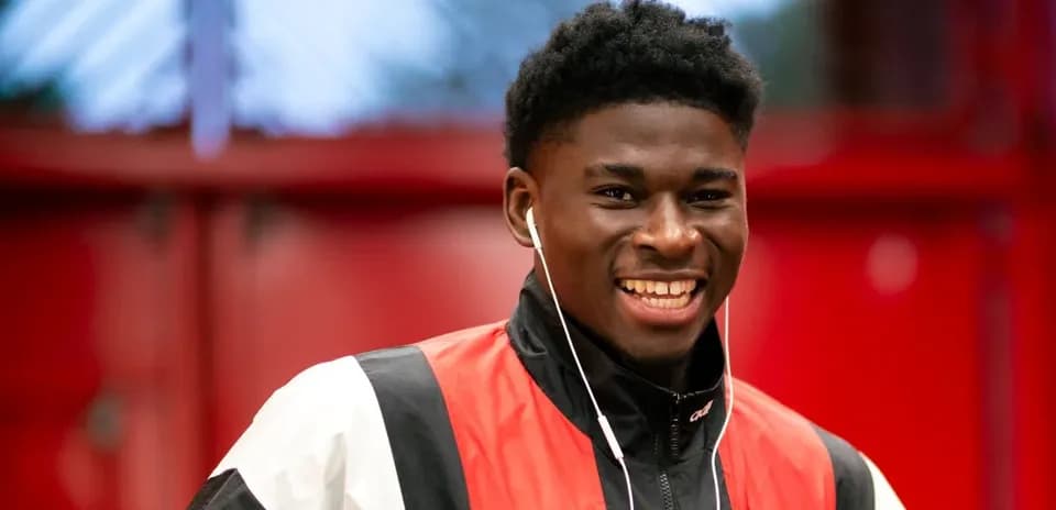 Player smiling while wearing headphones indoors