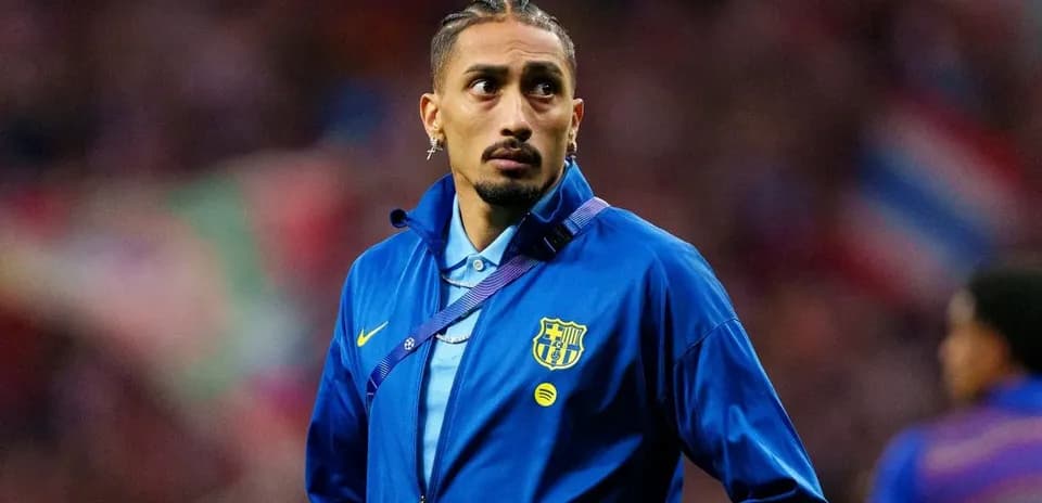 Player wearing FC Barcelona jacket on the pitch