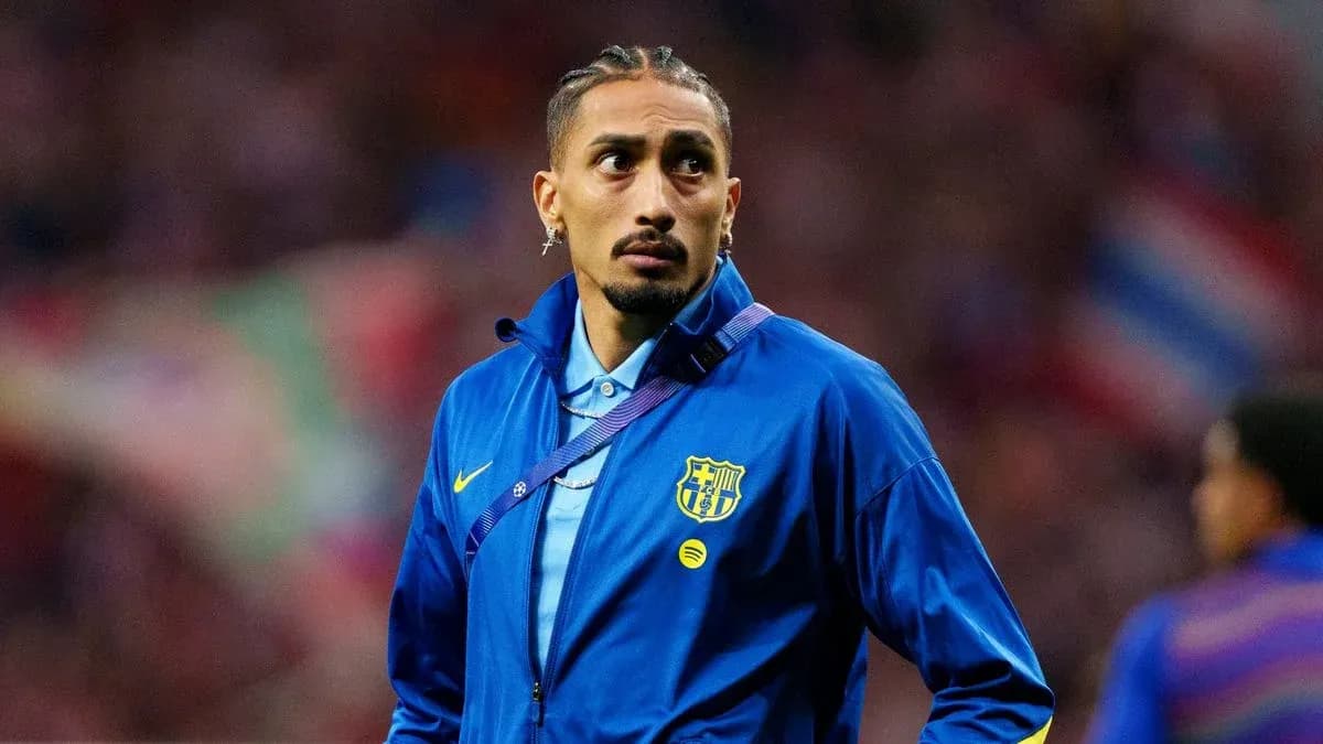 Player wearing FC Barcelona jacket on the pitch