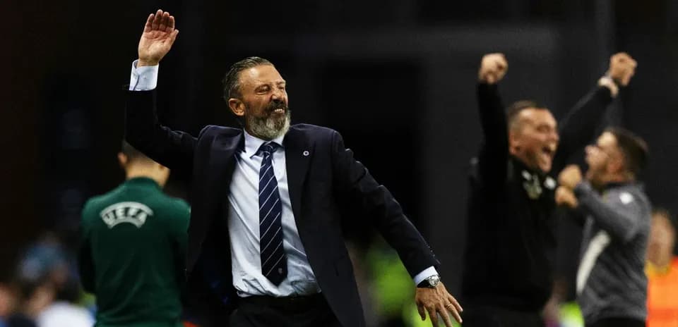 Coach celebrating with staff after match victory