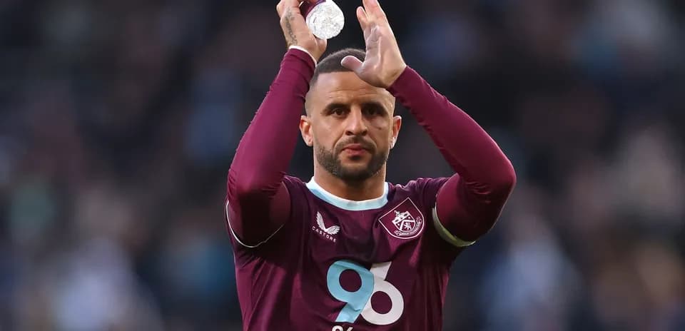 Player applauding fans while holding a water bottle