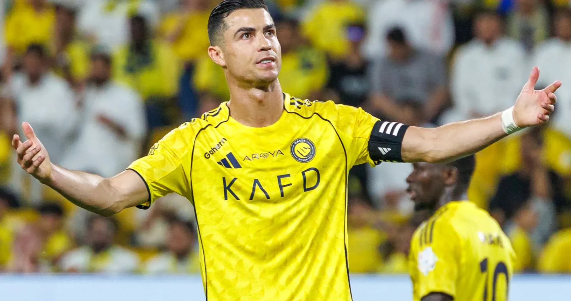 Player gesturing during match in yellow jersey