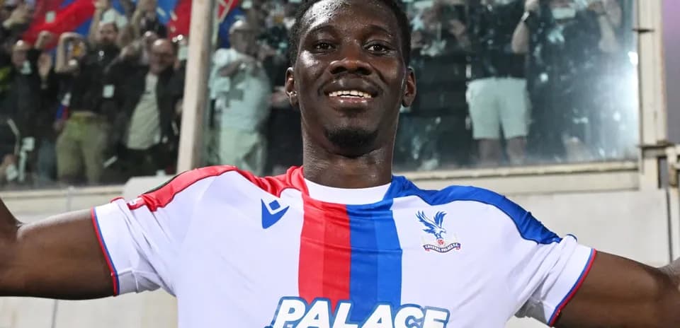Player celebrating in Crystal Palace kit with fans
