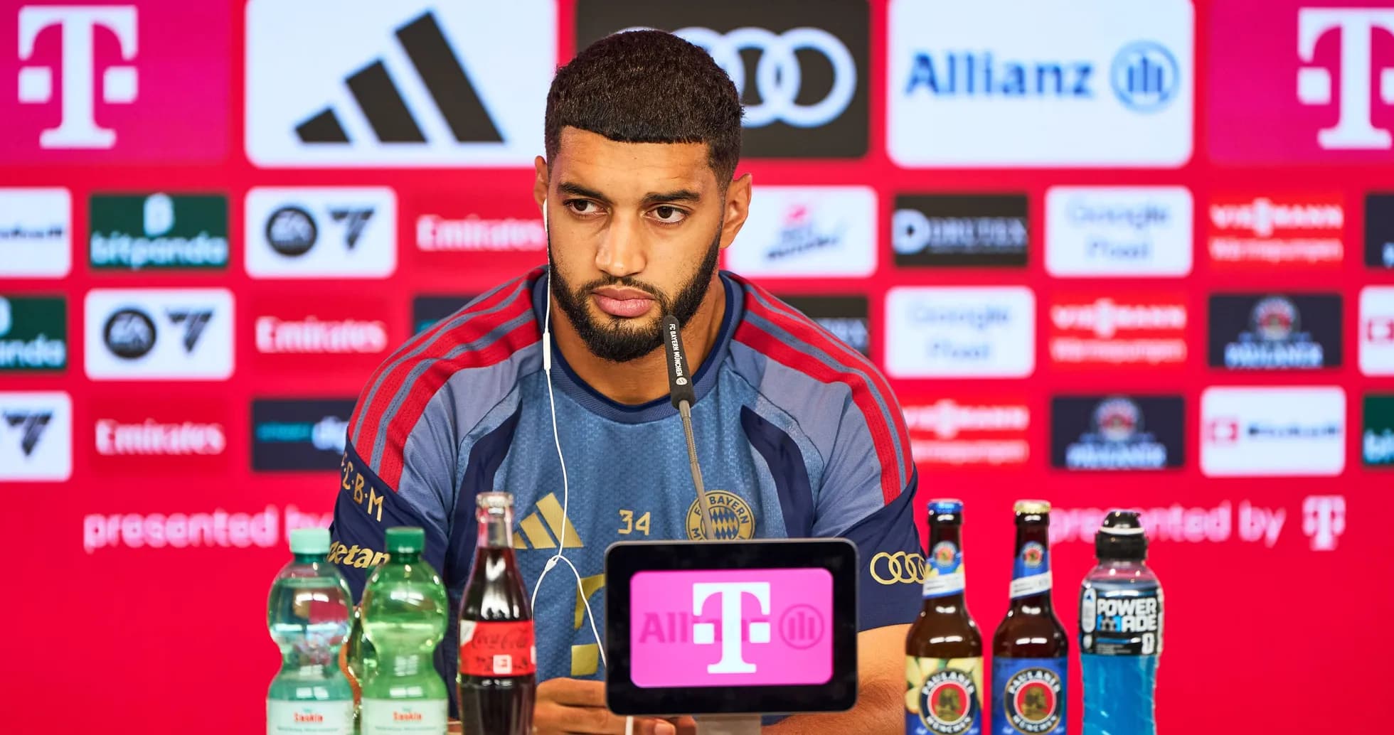 Player at press conference with beverages on table