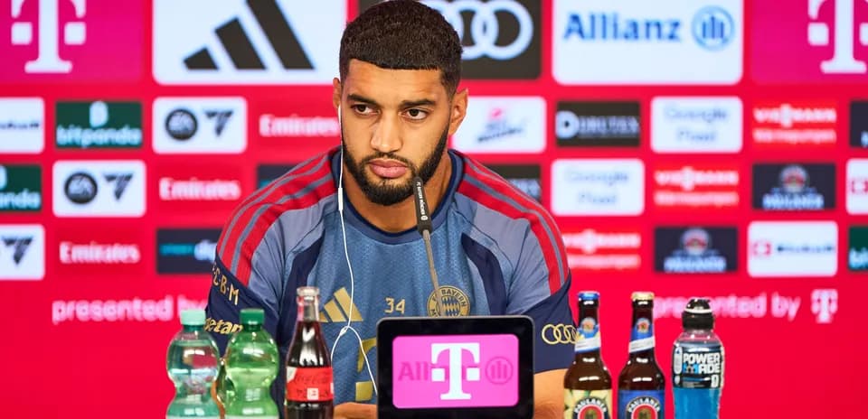 Player at press conference with beverages on table