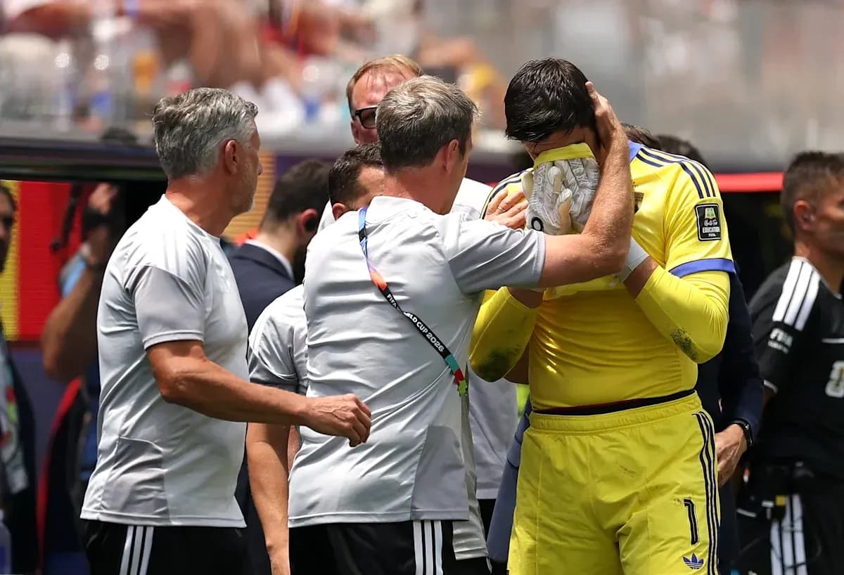 Coach comforting goalkeeper on the sidelines