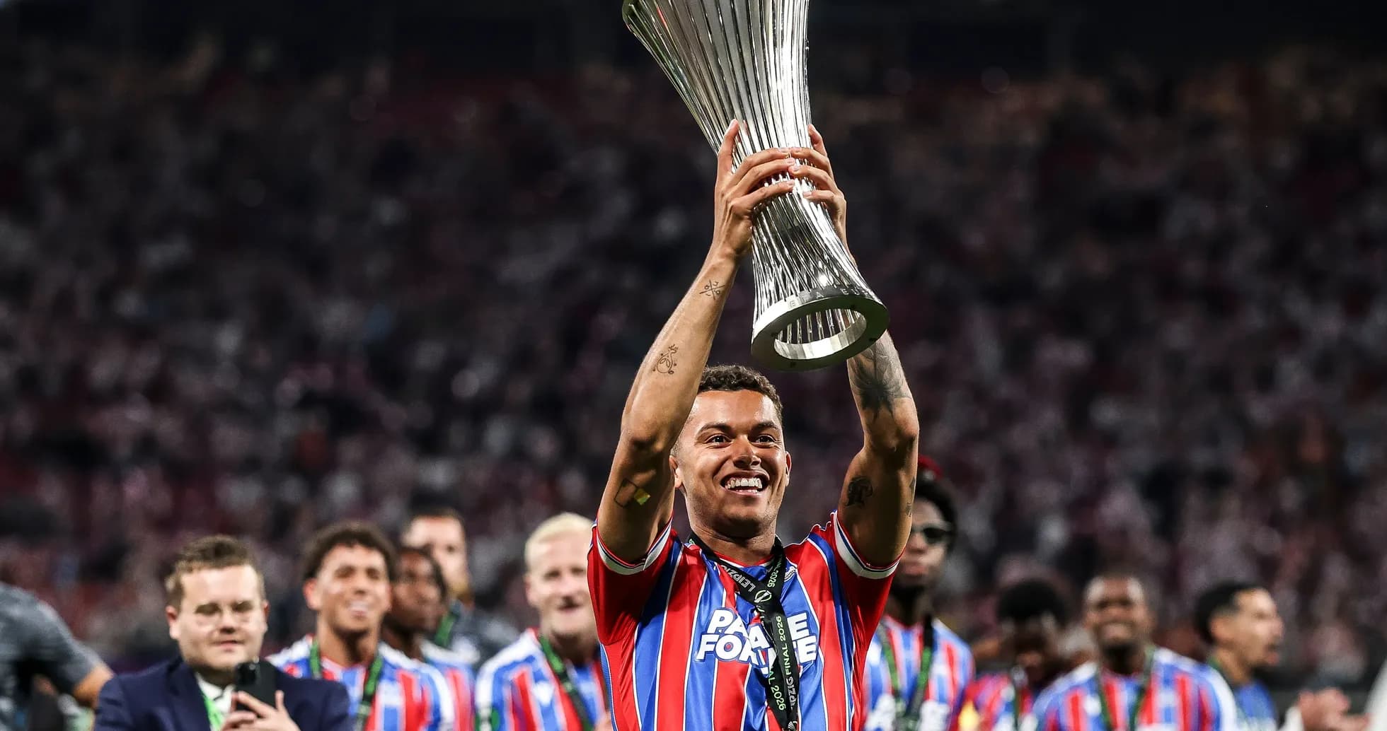 Player celebrating with trophy after winning match