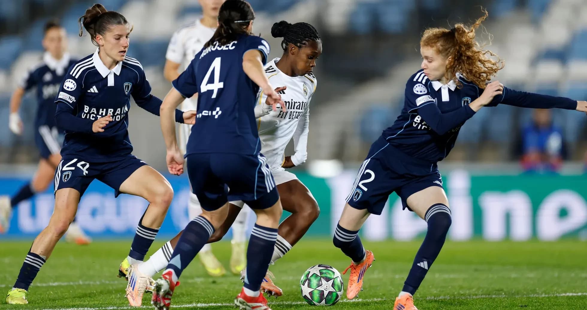 Real Madrid player dribbling against Paris FC defenders