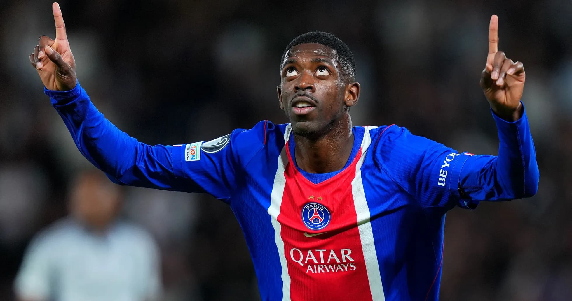 Player celebrating goal with raised finger at stadium