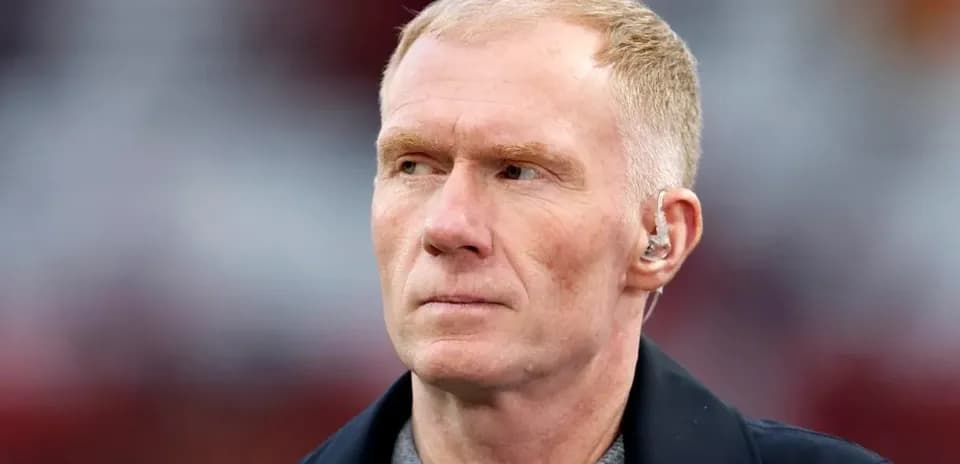 Person with short hair and earpiece on field