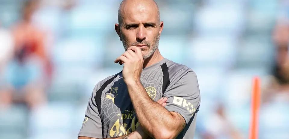 Coach observing players during training session