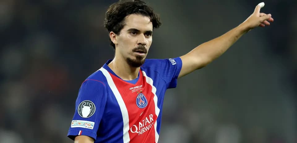 Player gesturing during match wearing PSG jersey