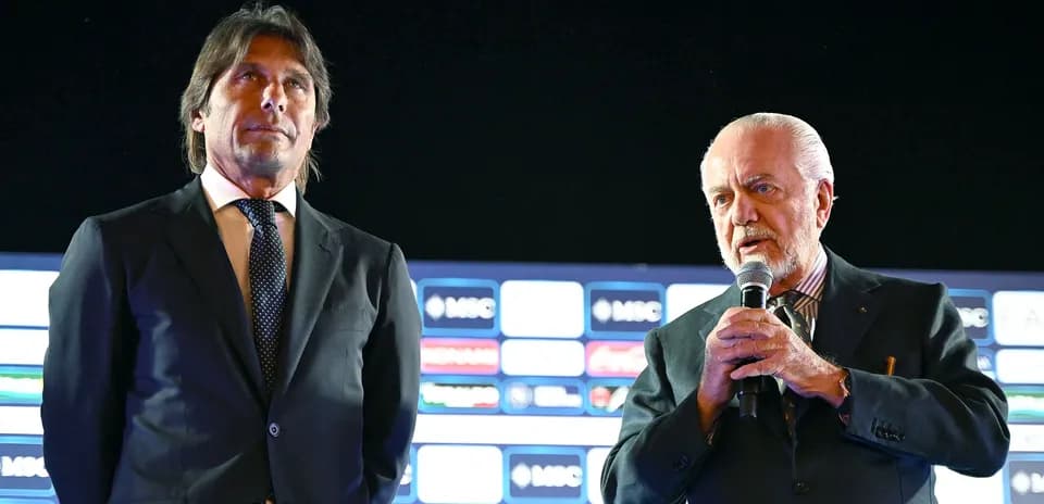 Two men at a press conference with microphones