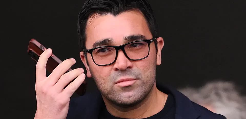 Man holding a phone while looking ahead