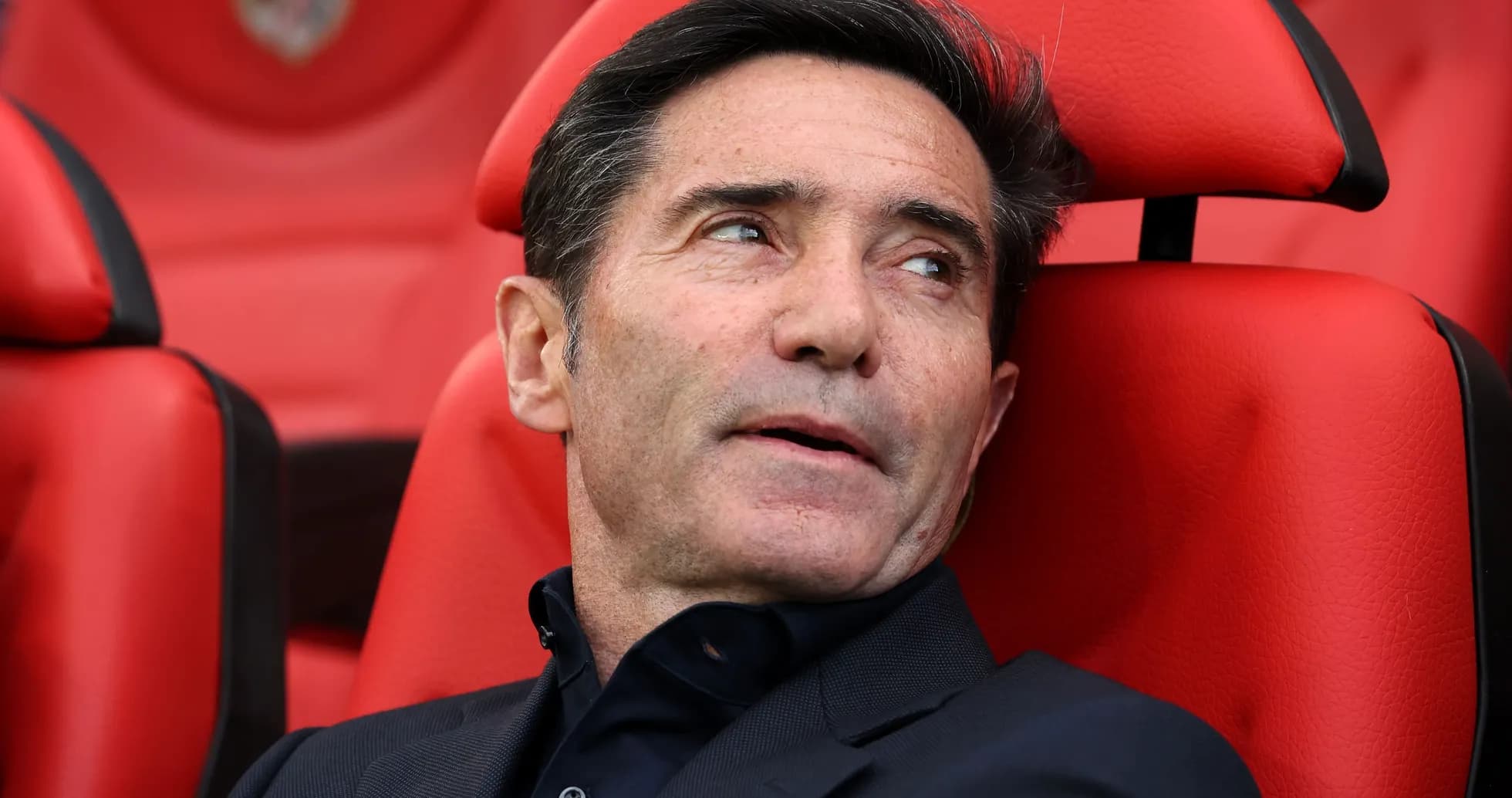 Coach sitting on bench during match