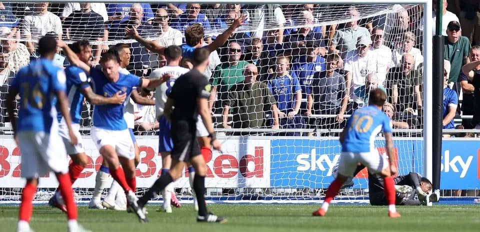 Players reacting during a goal attempt in match