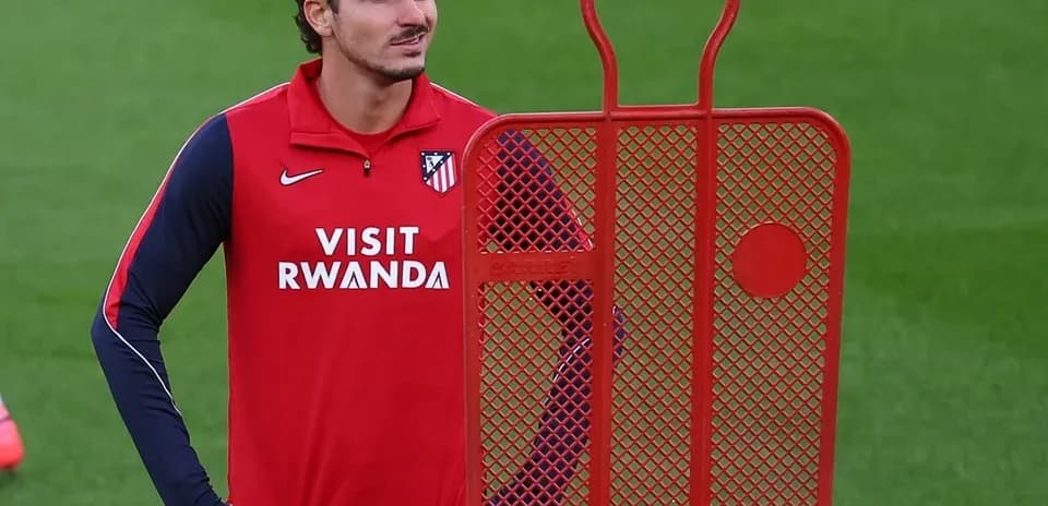 Player standing beside training dummy on field