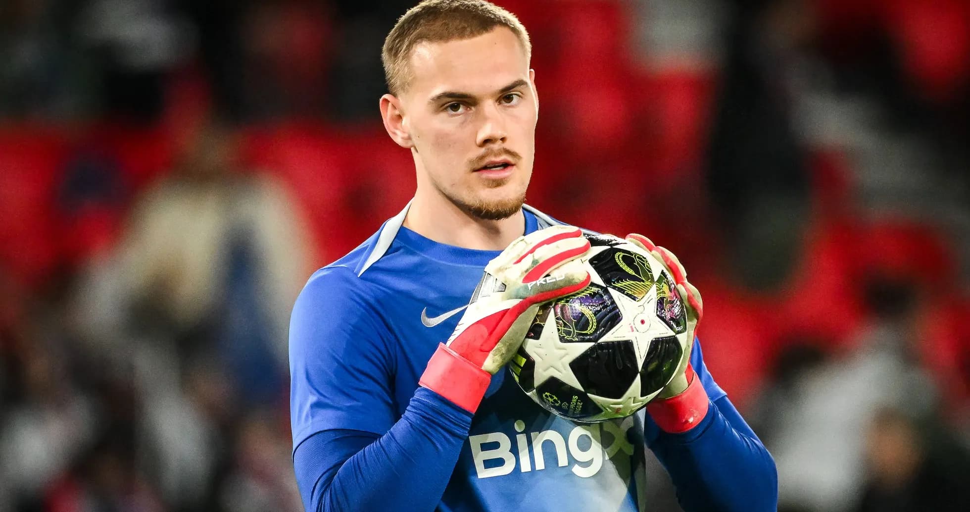 Goalkeeper holding a football before the match