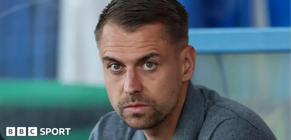 Man sitting in stadium, focused expression