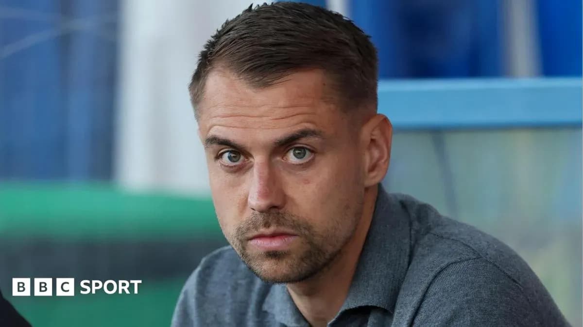 Man sitting in stadium, focused expression
