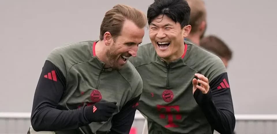 Two Bayern Munich players laughing during training session