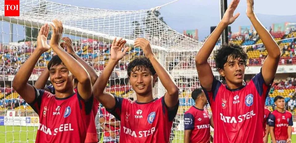 Three players celebrating in team jerseys after match