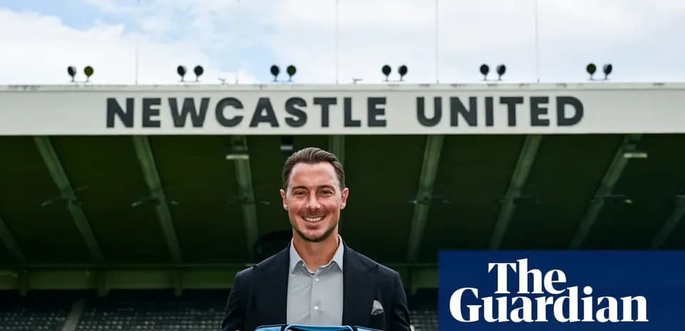 Player holding Newcastle United shirt at stadium