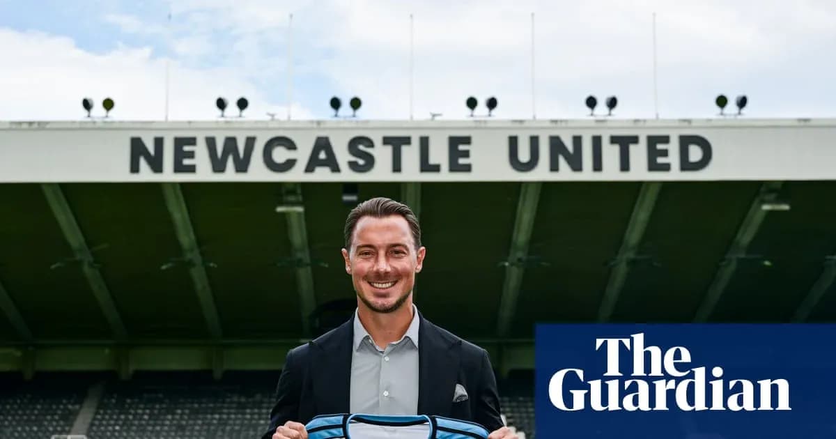 Player holding Newcastle United shirt at stadium