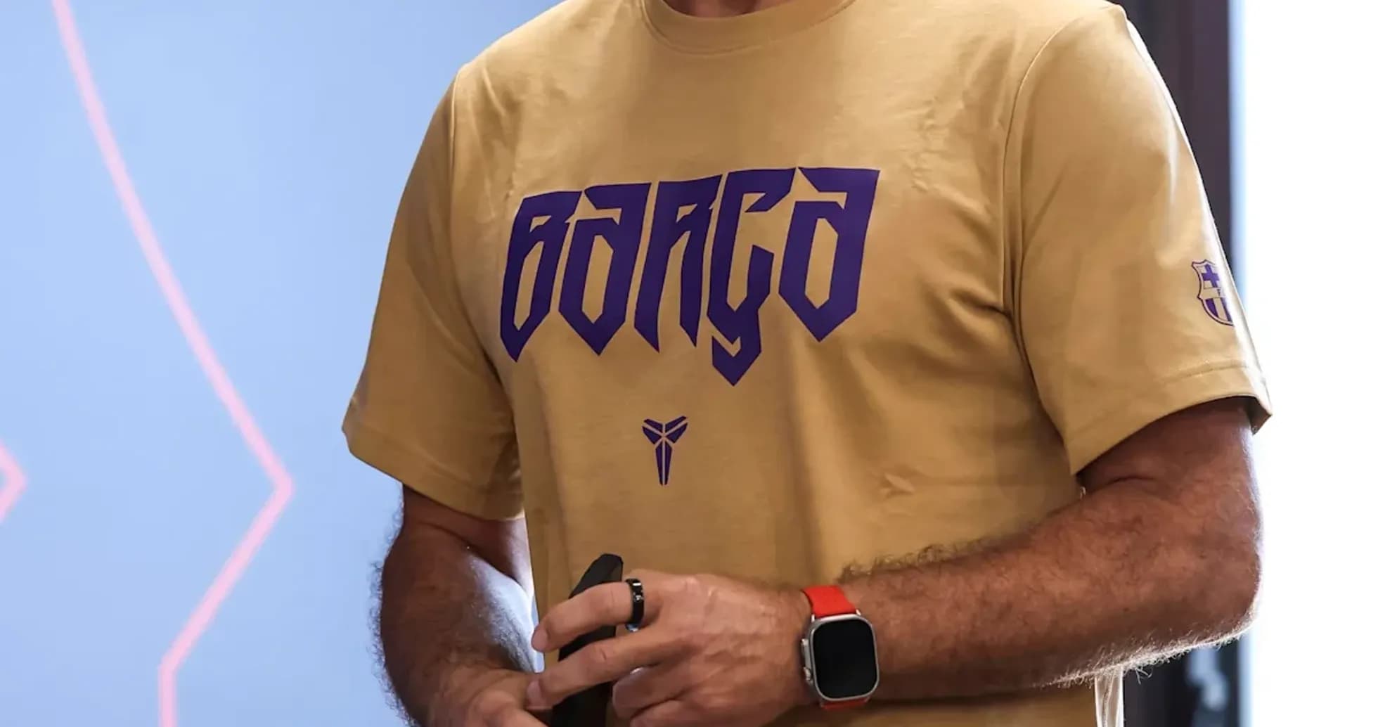 Coach holding a water bottle in training facility