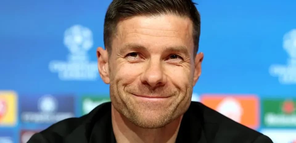Coach smiling at UEFA Champions League press conference