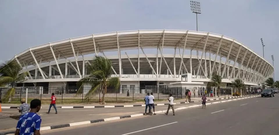 Exterior view of stadium with pedestrians nearby